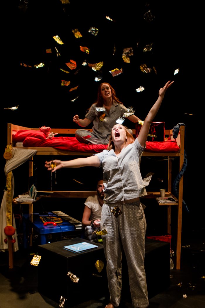 Image of Kylie and Jemma from Broke - Jemma is sat on the top bunk throwing gold into the air with Jemma looking on