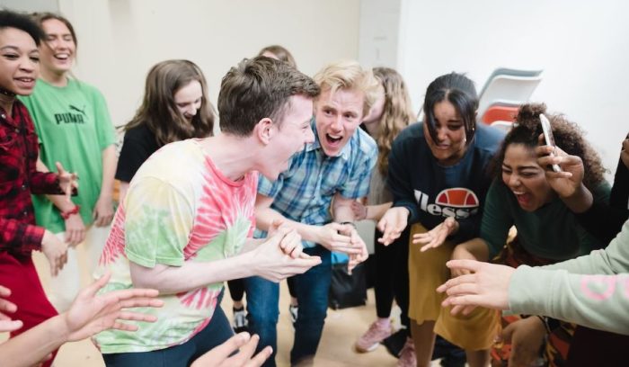 Group of young people gathered together in Workshop looking engaged and happy