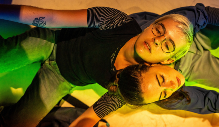 Two people lie looking up to the stars - image to announce the new tour of Feel Me